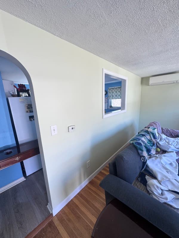 Painted living room with cream walls and arched doorway in Methuen, MA
