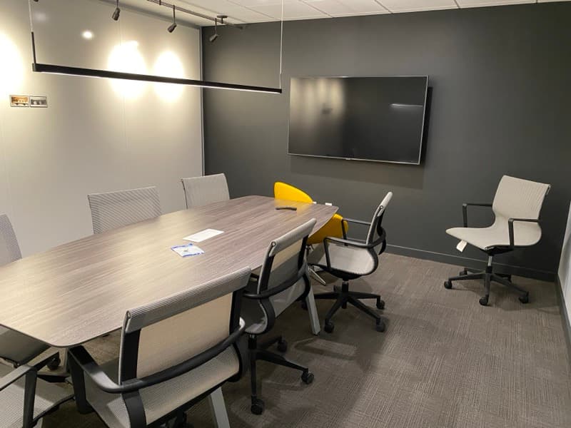 Conference room with dark gray accent wall and modern lighting in Salem, NH