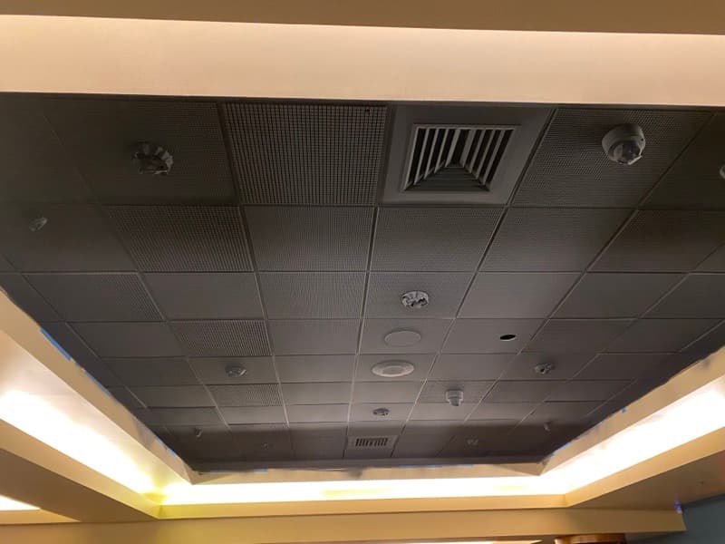Commercial painted ceiling with dark tiles and cove lighting in Seabrook, NH